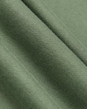 A close-up of olive green fabric with a ribbed texture, reminiscent of the KIDS PACIFIC CHENILLE HOODIE by Psycho Bunny. The fabric falls into soft folds, accentuating its smooth and slightly shiny surface similar to the chenille embroidery on this Psycho Bunny piece.