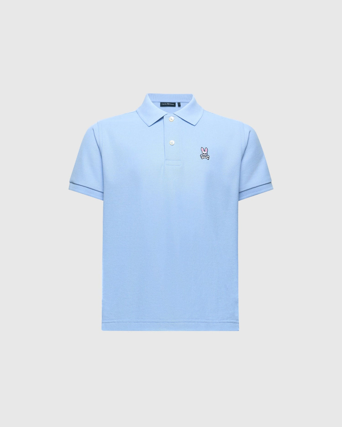 The Kids Classic Pique Polo (B0K001B200) by Psycho Bunny is crafted from soft Pima cotton in light blue, featuring a collar, short sleeves, and an embroidered Bunny logo on the left chest against a plain light gray background.