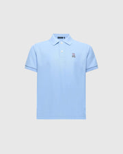 The Kids Classic Pique Polo (B0K001B200) by Psycho Bunny is crafted from soft Pima cotton in light blue, featuring a collar, short sleeves, and an embroidered Bunny logo on the left chest against a plain light gray background.