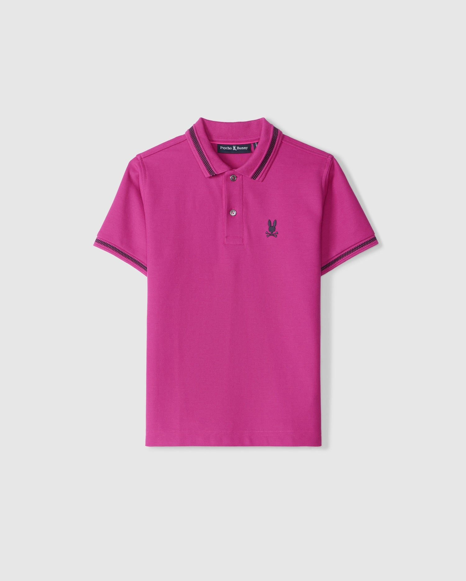 The KIDS RIVIERA PIQUE POLO SHIRT - B0K640C200 by Psycho Bunny is made from luxurious Pima cotton piqué, showcasing a vibrant magenta color with short sleeves. It features an embroidered chest logo of a playful bunny that contrasts with the dark design. The stylish look is completed with matching striped trim on the collar and cuffs.
