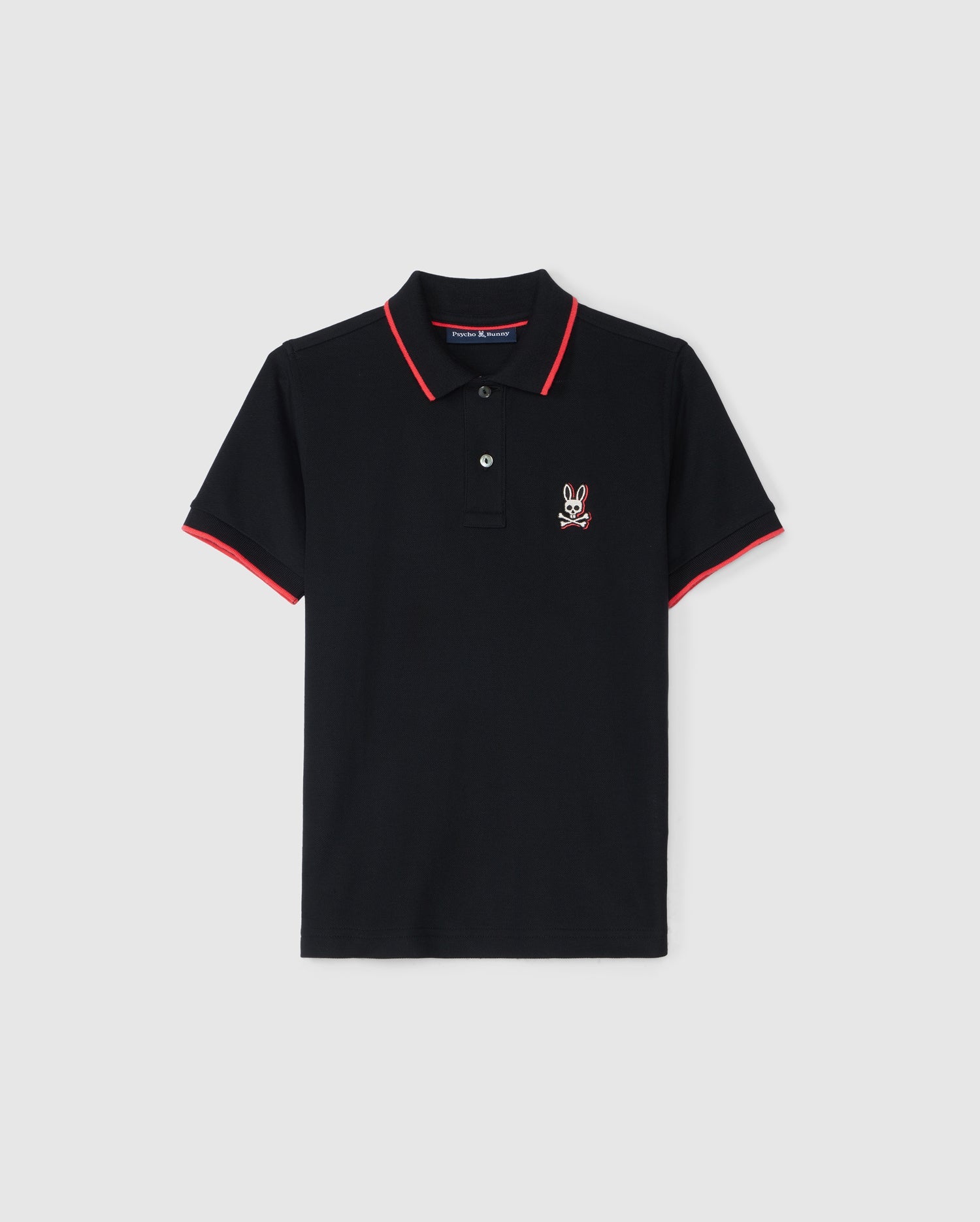 The KIDS KAYDEN PIQUE POLO - B0K675C200 by Psycho Bunny is a black polo shirt accented with red trim on the collar and sleeve cuffs. It has a small, white, embroidered rabbit logo on the left chest. Crafted from Pima cotton piqué, this shirt features a two-button placket and is showcased against a plain white background.