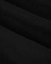 Close-up image of a piece of black fabric, reminiscent of the luxurious texture found in a Psycho Bunny KIDS MALTON PIQUE POLO SHIRT (B0K950D200). The material appears textured and has a matte finish, with subtle shading indicating folds and gentle waves.