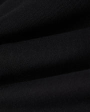 Close-up view of the black cotton fleece fabric with visible ribbing and slight texture, creating a series of gentle horizontal waves, perfect for the Psycho Bunny KIDS LENOX REGULAR FIT SWEATPANT.