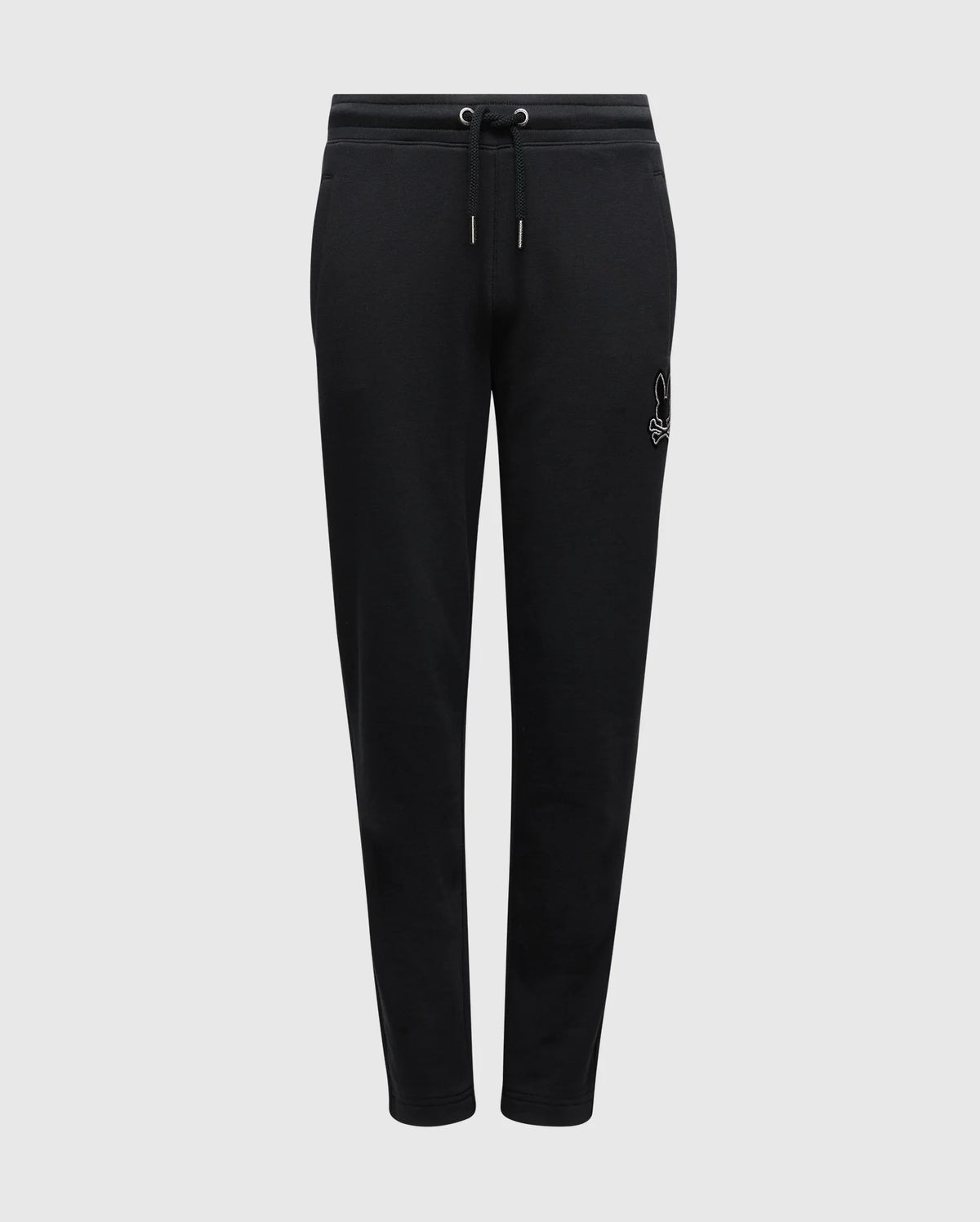 Introducing the Psycho Bunny KIDS ALEXANDER SWEATPANT - B0P155E200, crafted from a black cotton blend material. These joggers feature an elastic waistband with a drawstring for added comfort, and display a subtle white embroidered logo on the left thigh. Equipped with front pockets, these cozy sweatpants are presented against a plain white background.