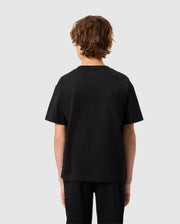 A person with curly brown hair, facing away from the camera, is wearing a plain black T-shirt and KIDS MONROE TWILL PATCH FLEECE SWEATPANT by Psycho Bunny in soft cotton fleece against a light gray background, highlighting subtle luxury finishes.