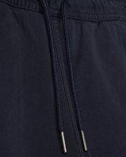 Close-up of a black fabric drawstring with metal aglets on Psycho Bunny's KIDS WILLIS STRETCH TENCEL SHORT - B0R239Y1WB clothing, focusing on the texture and details of the material and drawstring.