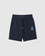 The KIDS LENOX SWEATSHORT by Psycho Bunny, in navy blue, is ideal for an active lifestyle with its drawstring waistband. Made from naturally breathable fleece, it features a small embroidered blue and yellow cartoon bunny with crossed bones on one leg, offering kids comfort and style.