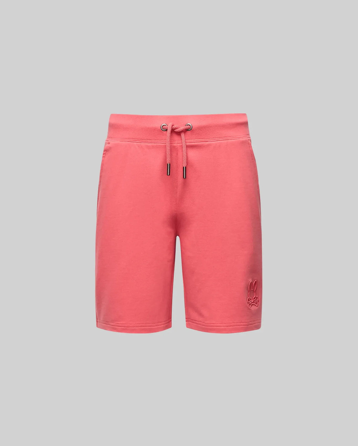 The KIDS LEVANZO EMBROIDERED MICRO FRENCH TERRY SWEATSHORT by Psycho Bunny features a coral pink shade, drawstring waistband with metal eyelets, and lower left leg embroidered logo, shown against a plain light gray background.