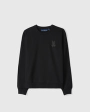 The KIDS HOUSTON FRENCH TERRY CREWNECK by Psycho Bunny is a black pullover sweatshirt made from premium cotton fabric. It features a subtle embossed bunny graphic on the upper left chest and has ribbed cuffs along with a ribbed hem, all set against a light gray background.