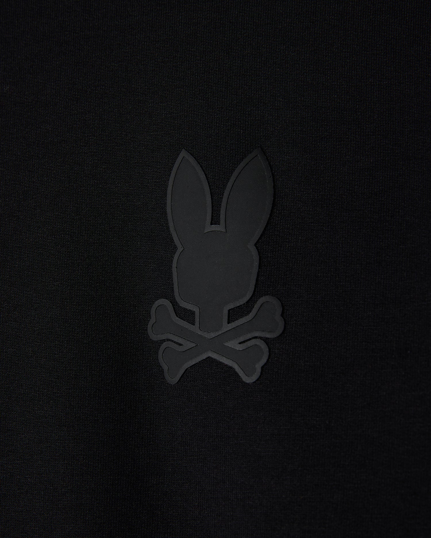 The KIDS HOUSTON FRENCH TERRY CREWNECK - B0S462C200 by Psycho Bunny features a black background with a minimalist, monochromatic bunny head design alongside crossed bones, giving it a pirate skull and crossbones vibe. Made from premium cotton fabric, this lightweight piece brings an edgy elegance to your collection.