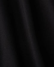 Close-up of a smooth black fabric crafted from luxurious Pima cotton on Psycho Bunny's KIDS HAWAII CITY TEE - B0U169Y1PC, featuring subtle diagonal lines and a soft sheen, evoking the sleek elegance reminiscent of volcanic island landscapes.
