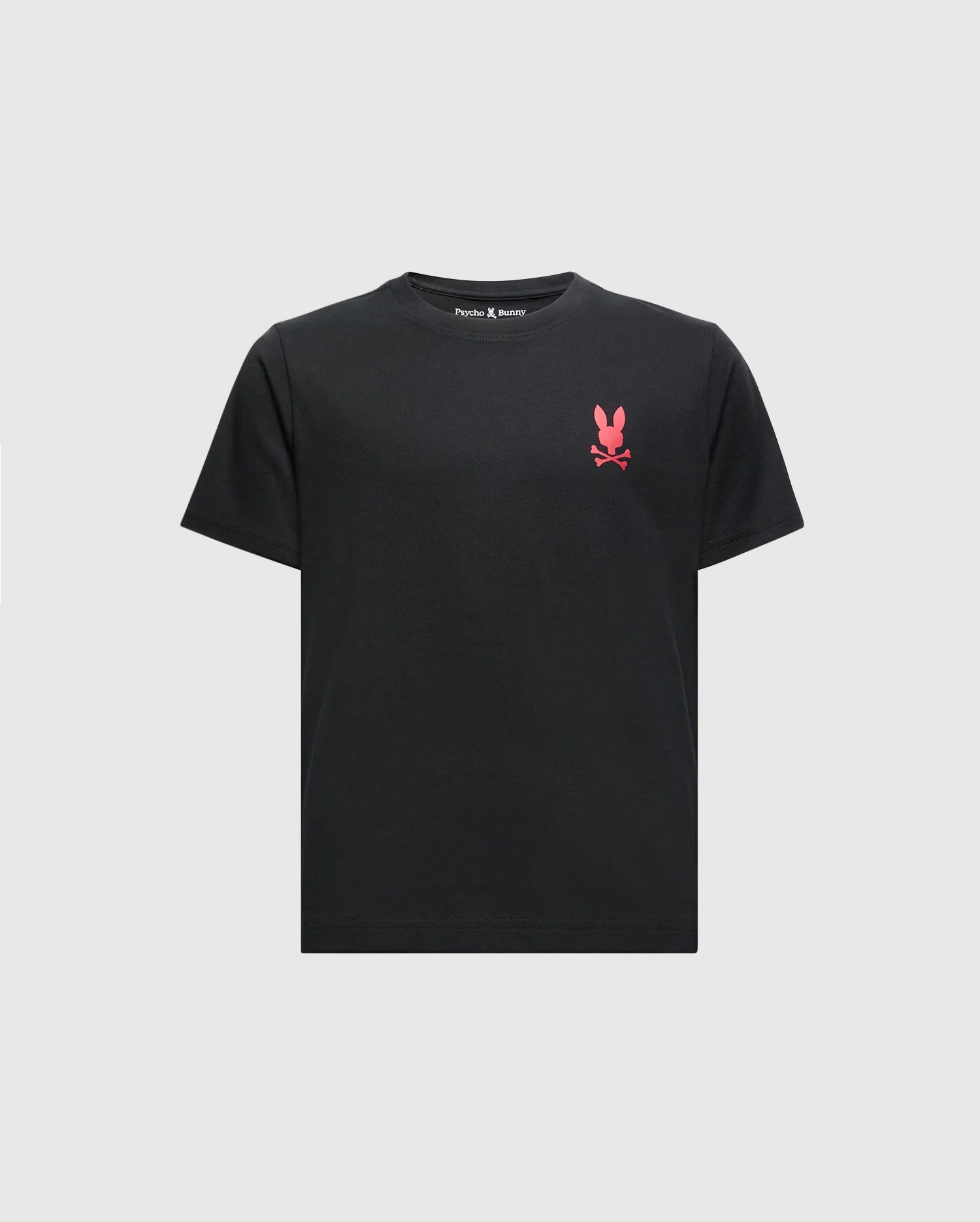 This fashionable KIDS RIO BACK GRAPHIC TEE - B0U363E200 in black features a small pink skull and crossbones on the upper left, made from soft Peruvian Pima cotton. The shirt proudly displays the Psycho Bunny brand inside the collar against a plain white background.