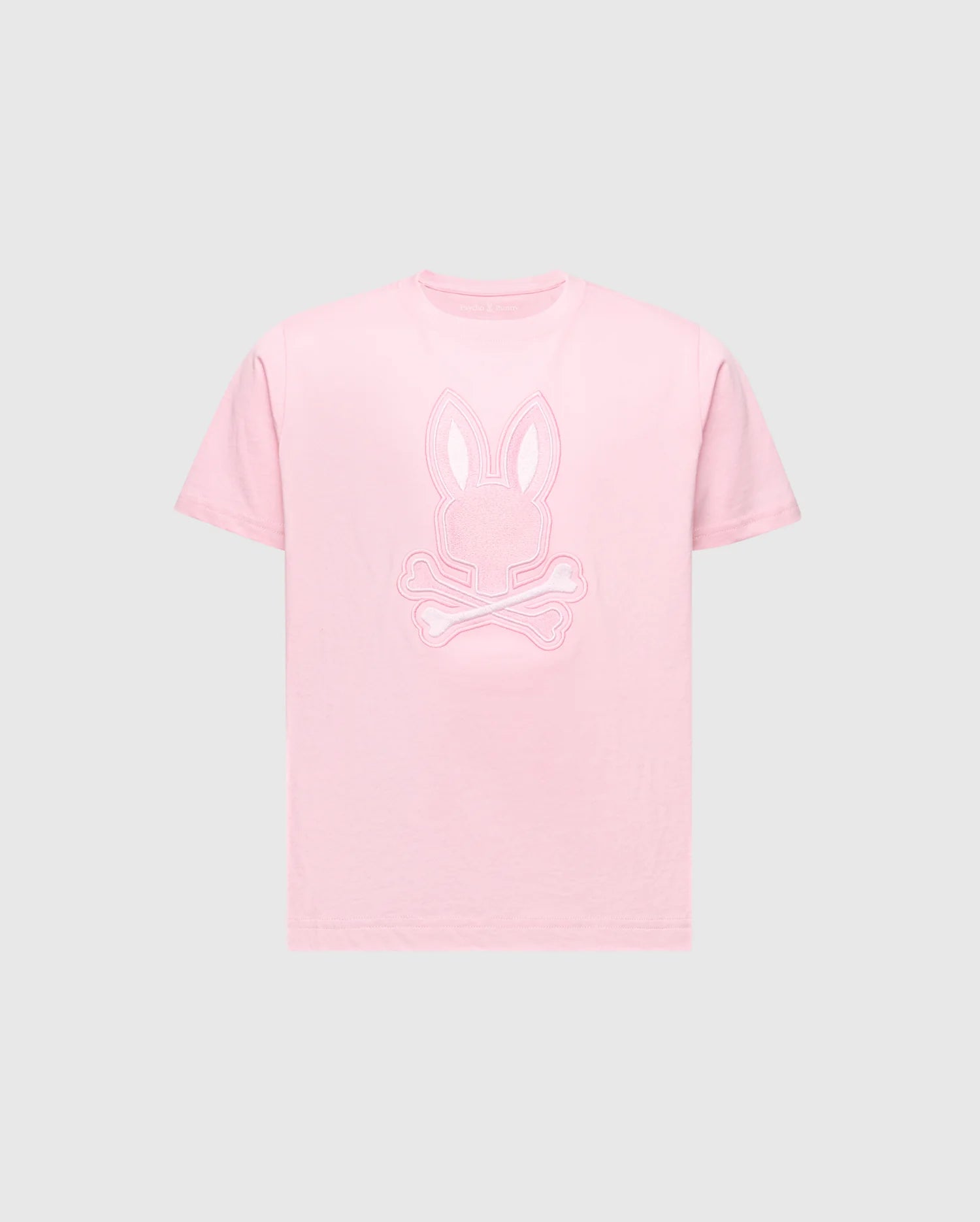 The Psycho Bunny KIDS NEW CASTLE EMBROIDERED GRAPHIC TEE (B0U415F200) features a pink embroidered Bunny head and crossed bones on a light grey background, made from soft Pima cotton for comfort.