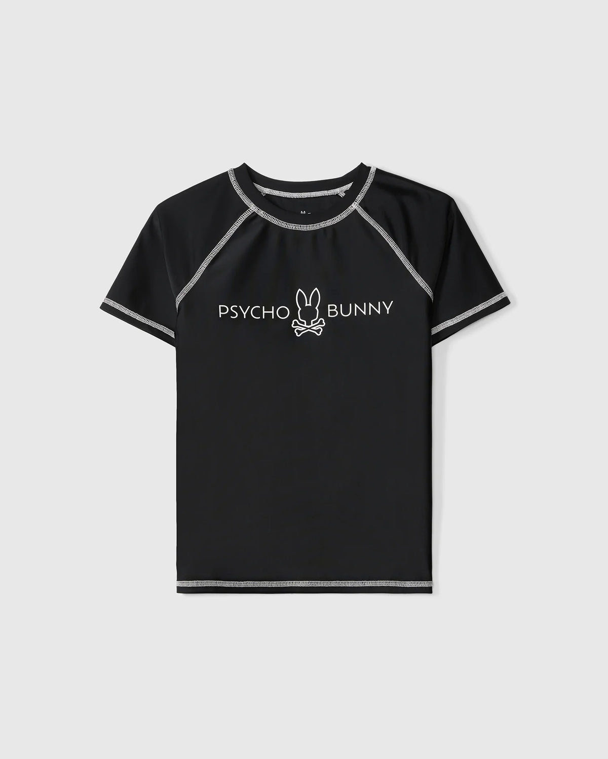 A black, short sleeve rashguard with grey stitching. The shirt features the "Psycho Bunny" logo in white across the chest, complete with a bunny's head and bones underneath the text. Ideal for kids, it offers UPF 50+ protection. The product is called KIDS SHORT SLEEVE ANTI-UV RASHGUARD - B0U558C200 from Psycho Bunny.