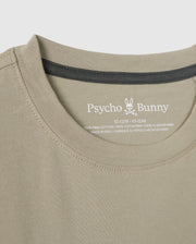 Close-up of the neckline and collar of the KIDS MELVIN GRAPHIC TEE - B0U663C200 by Psycho Bunny. The inner label shows the brand's name with a bunny logo, the size 10-12M, and the material (100% Pima cotton). Also featured is an HD-silicone print, highlighting that it's made in Peru.