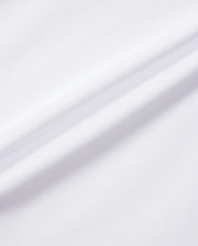 A close-up shot of the white KIDS MELVIN GRAPHIC TEE - B0U663C200 from Psycho Bunny showcases the Pima cotton fabric's soft, smooth texture, with a subtle diagonal crease running through the middle. The lighting accentuates the fabric’s clean and minimalist appearance, making it perfect for graphic applications.