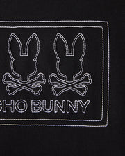The KIDS TACOMA GRAPHIC TEE - B0U909D200 by Psycho Bunny features two outlined bunny heads with crossbones on a black background, with "PSYCHO BUNNY" embroidered in white below. Made from soft Pima cotton, the design is neatly enclosed within a rectangular stitched border.