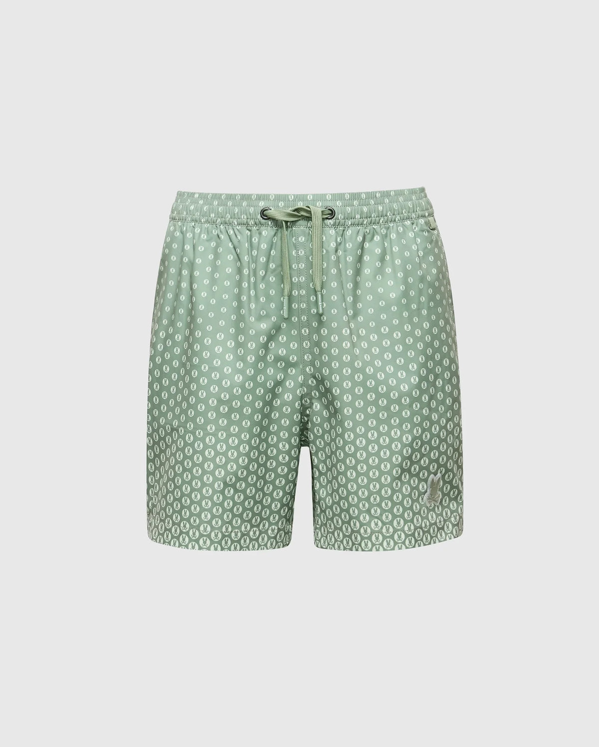 The KIDS BENDIGO PRINTED SWIM TRUNK - B0W619F200 by Psycho Bunny features light green swim shorts with white polka dots, crafted from quick-dry fabric. They have a drawstring waistband and are perfect for summer. Stored in a waterproof bag against a plain white background.