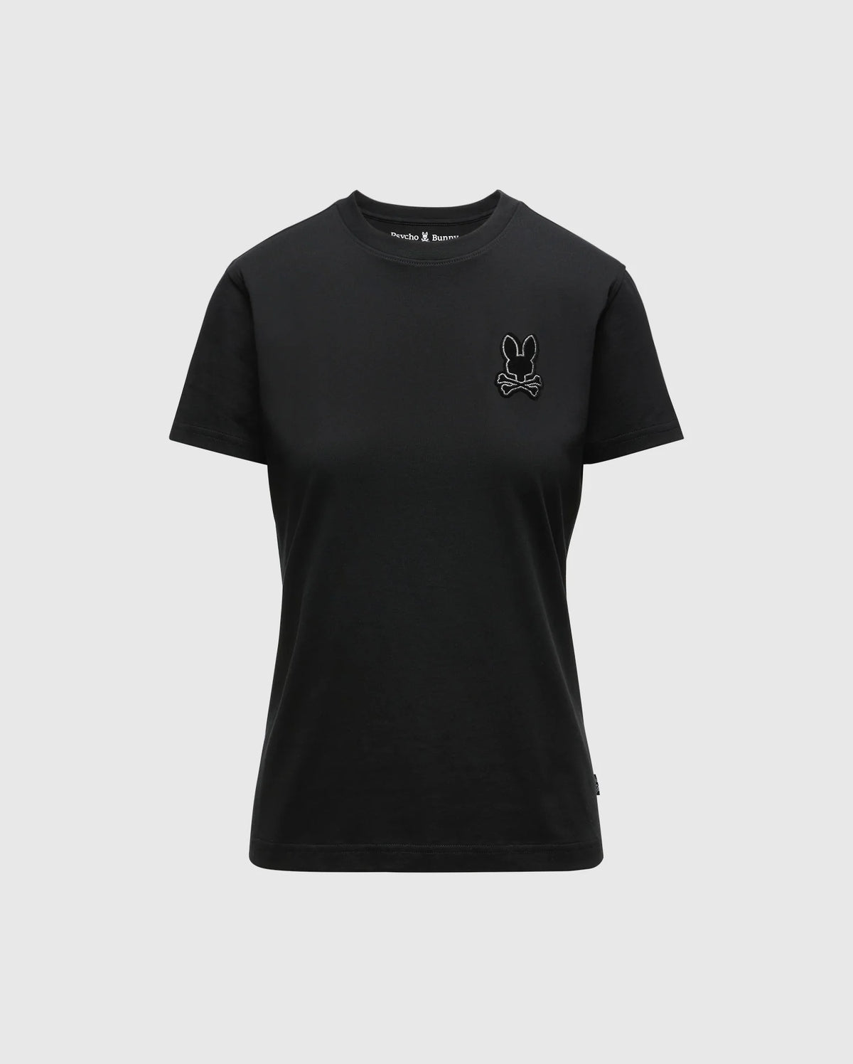This unisex black Women's Alexander Graphic Tee - B2U164E200 by Psycho Bunny is made from premium Pima Cotton and showcases a small embroidered rabbit and crossed bones logo on the left chest. With its simple design, short sleeves, and round neckline, this T-shirt combines style with comfort.