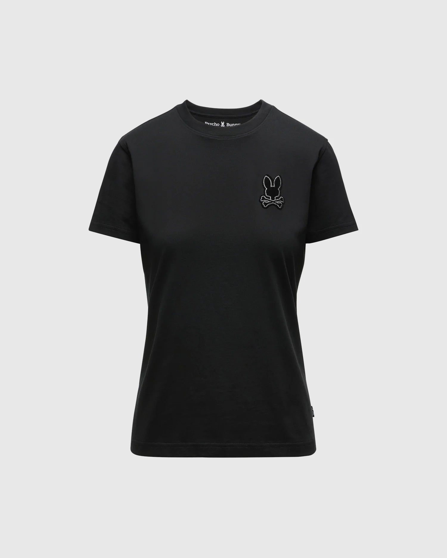 This unisex black Women's Alexander Graphic Tee - B2U164E200 by Psycho Bunny is made from premium Pima Cotton and showcases a small embroidered rabbit and crossed bones logo on the left chest. With its simple design, short sleeves, and round neckline, this T-shirt combines style with comfort.