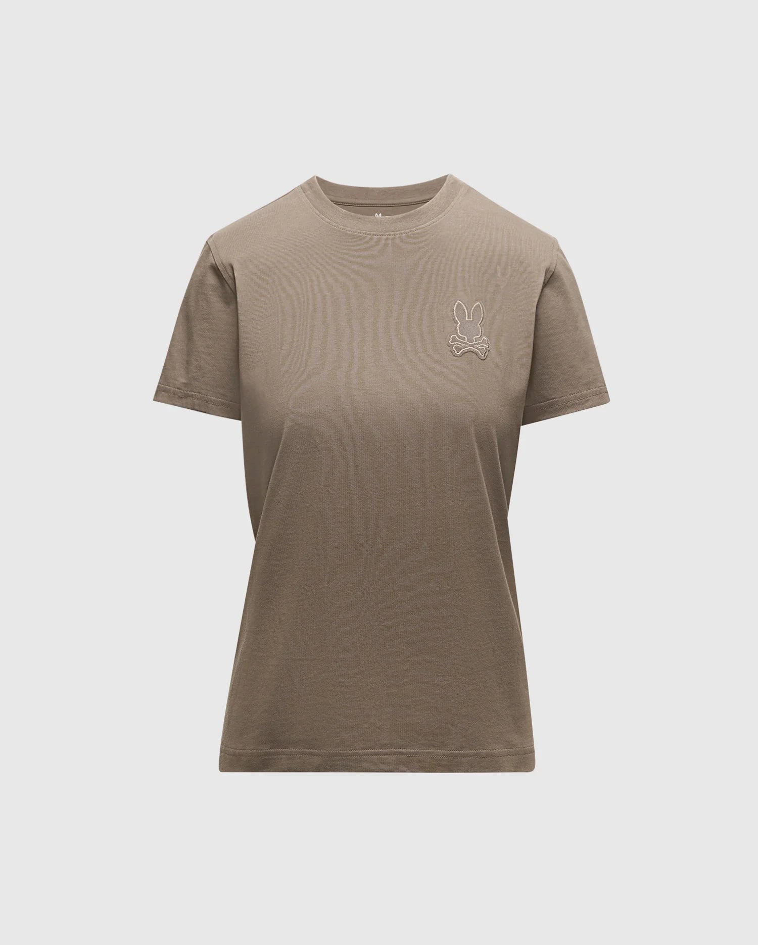 Introducing the WOMENS ALEXANDER GRAPHIC TEE by Psycho Bunny, a classic plain brown tee made from luxurious Pima cotton. It showcases a subtle Lurex embroidered bunny logo on the upper left side. Designed with a round neckline and short sleeves, this piece offers comfort and style with its light grey backdrop.