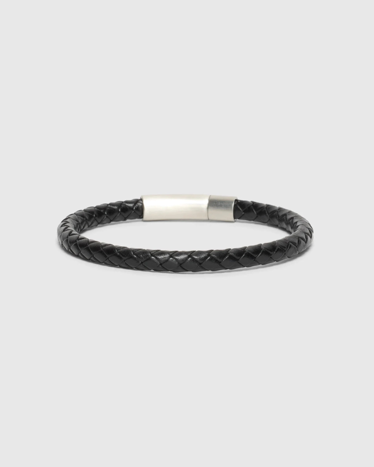 The Psycho Bunny Men's Braided Leather Bracelet (B6A371E200) in sleek black, features a silver clasp and combines durability with style against a neutral backdrop.