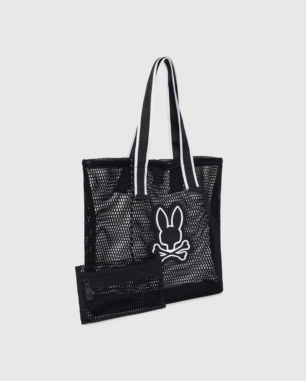 A black Psycho Bunny MENS MESH TOTE BAG - B6A388B200 with logo-webbing straps featuring a white outlined graphic of a rabbit head and crossed bones. Accompanied by a detachable zip pouch in matching black mesh with a zipper. The handles have white inner lining for contrast, set against a plain gray background.