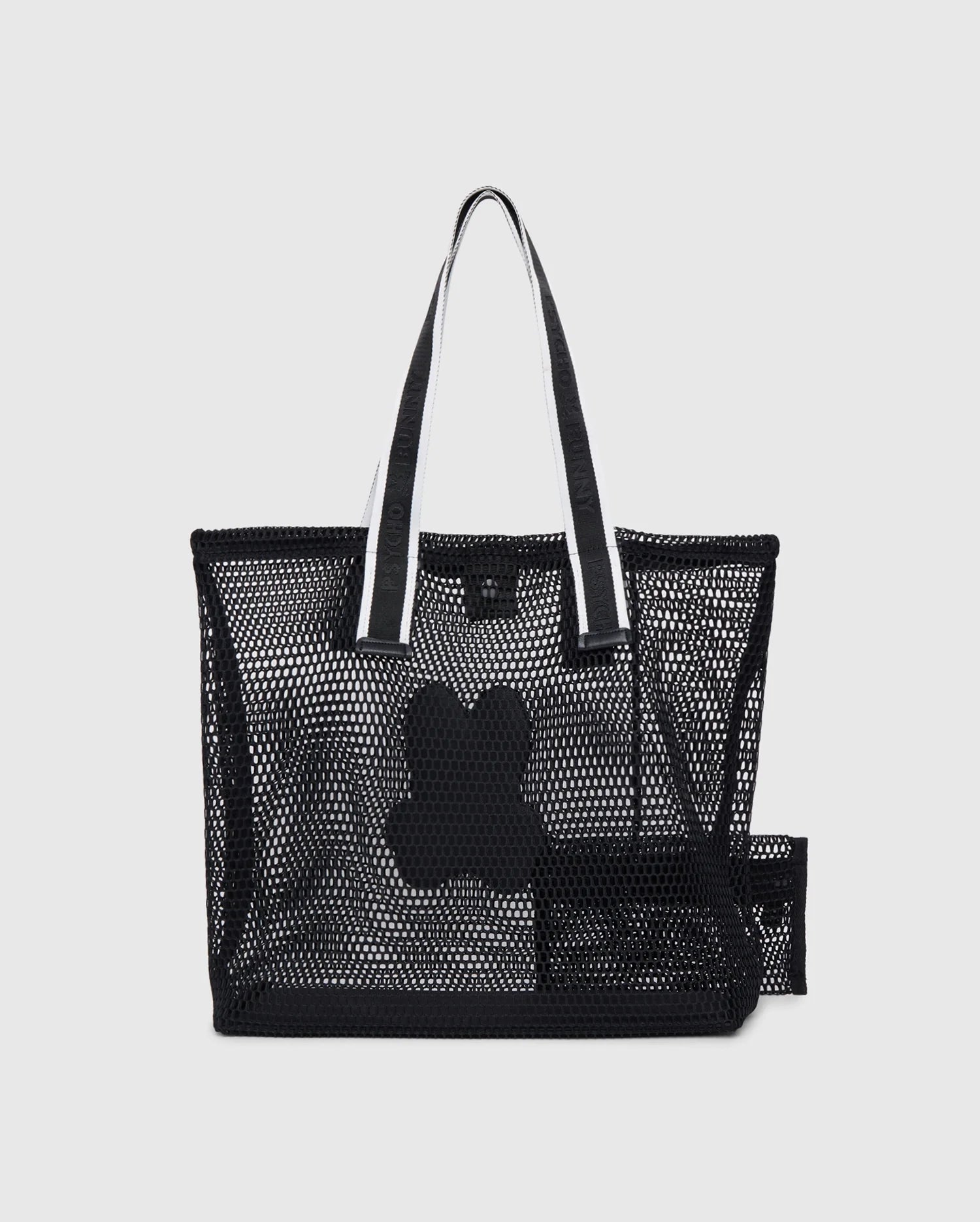 A black mesh tote bag with white handles featuring a medium-size black dog bone design in the center. Inside the tote, there's a detachable zip pouch made of black mesh. The logo-webbing straps add an extra touch of style against the plain white background. This is the MENS MESH TOTE BAG - B6A388B200 by Psycho Bunny.