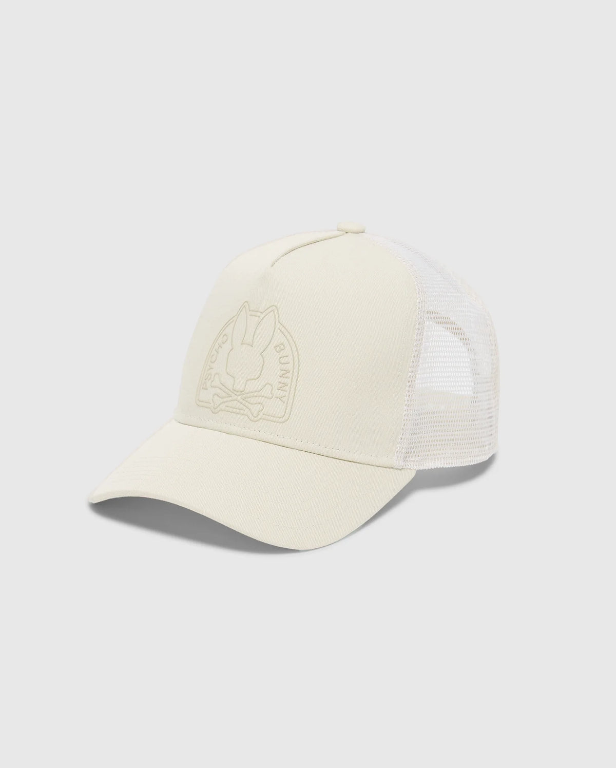 The MENS MELBOURNE GRAPHIC TRUCKER HAT by Psycho Bunny is light beige with a mesh back and curved brim. It features a subtle embossed bunny and crossbones on the front, complemented by an adjustable snap-back strap for the perfect fit.