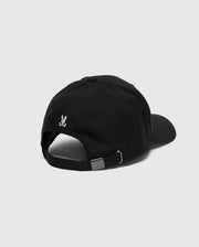 The Psycho Bunny MENS DESERT BASEBALL CAP (B6A549F200) features a black 100% cotton design with a small white eagle logo on the back. Its adjustable strap and metallic buckle are showcased against a light gray background.