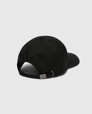 The MENS NICHOLSON PB BUNNY GRAPHIC BASEBALL CAP by Psycho Bunny, in black cotton twill with a curved brim, features an adjustable backstrap with a metal clasp and subtle stitching. The PB embroidery is present but not clearly readable against the light gray background.