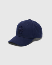 A navy blue cotton twill baseball cap from Psycho Bunny, featuring a curved brim against a light backdrop. The MENS NICHOLSON PB BUNNY GRAPHIC BASEBALL CAP showcases an embroidered "B" on the front and includes an adjustable backstrap for an ideal fit.
