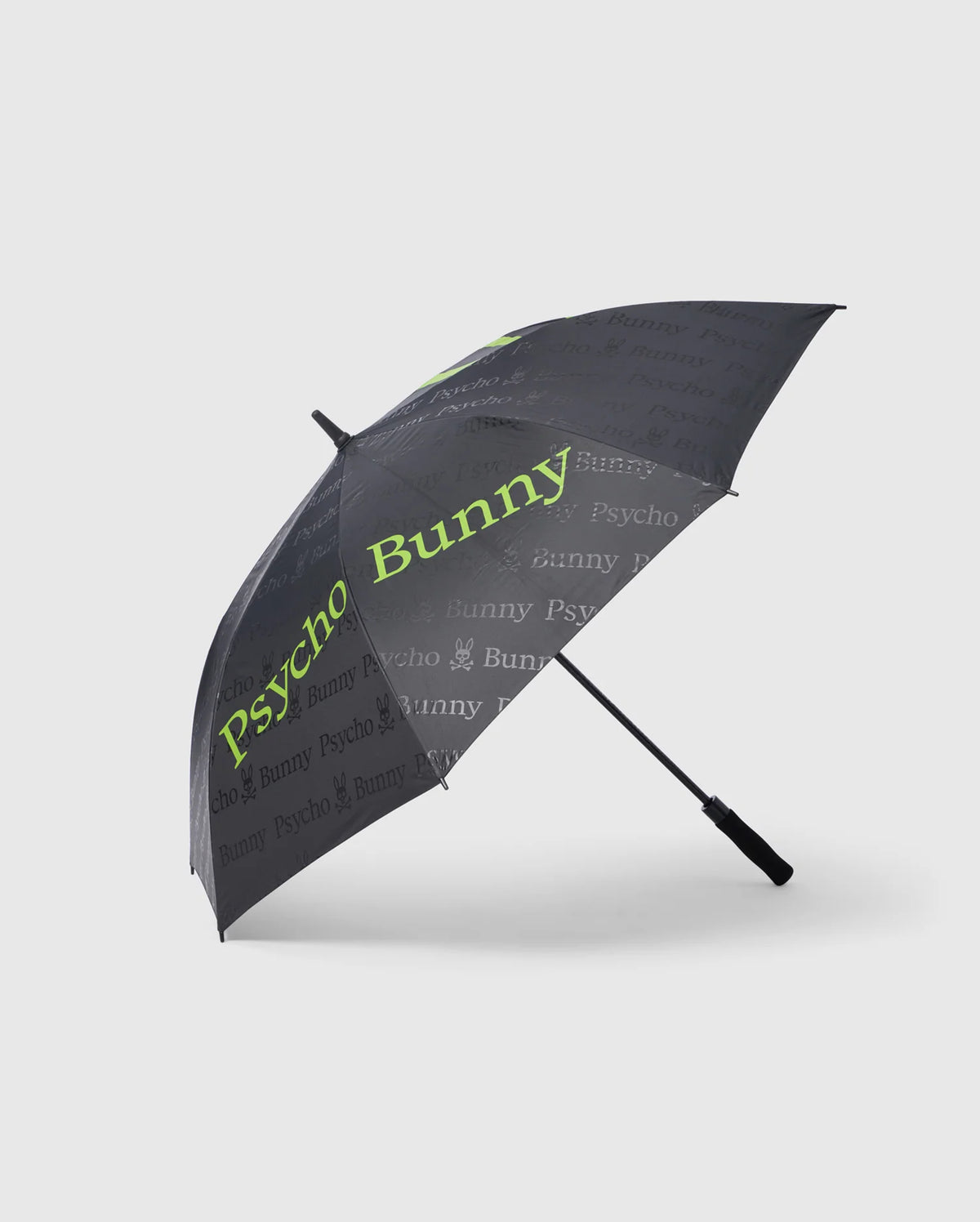 Introducing the GOLF UMBRELLA - B6A624C200 by Psycho Bunny: a stylish black collapsible umbrella adorned with "Psycho Bunny" repeatedly in grey and lime green text. This reliable accessory features a straight black handle and offers superior rain protection with its sleek, modern design.