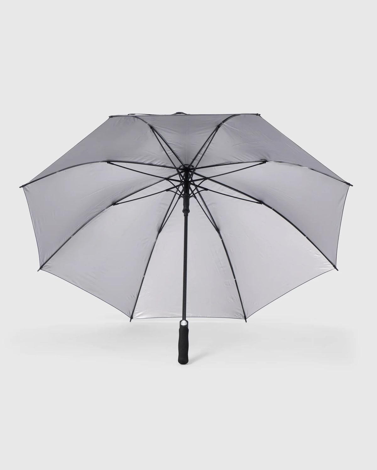 A large, open GOLF UMBRELLA - B6A624C200 from the Psycho Bunny brand features a collapsible design with a black frame and gray canopy. This dependable umbrella has a central black pole and handle, with clearly visible spokes set against a plain white background.