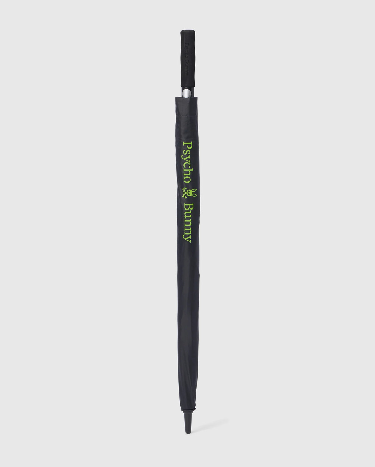 A black GOLF UMBRELLA - B6A624C200 with a matching handle is fully closed and sheathed. The sheath showcases green text and a small graphic, displaying "Psycho Bunny." Renowned for its dependable rain protection, this chic collapsible umbrella by Psycho Bunny stands out against the white background.