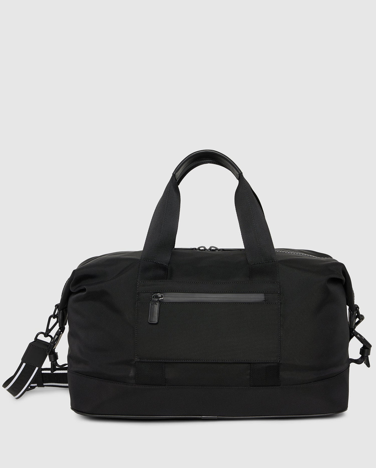 A sleek black MENS WEEKENDER BAG - B6A629Z1BG by Psycho Bunny with a front zippered pocket, two sturdy handles, and an adjustable shoulder strap. The bag has a minimalist design, with clean lines and a smooth finish, suitable for travel or gym use.