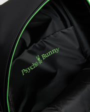 Close-up of the black MENS RUBBERIZED BACKPACK (B6A637F200) interior by Psycho Bunny, featuring a green bunny crossbones logo, showcasing its durable and functional design with robust lining and precise stitching.