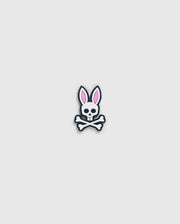 A graphic of a bunny skull and crossbones from the Psycho Bunny golfers collection. The skull has rabbit ears with pink interiors and a small bow tie under the chin. Crossbones form an "X" below the skull, perfect as the Psycho Bunny BALL MARKER - B6A698C200 with its playful design on a plain, light gray background.