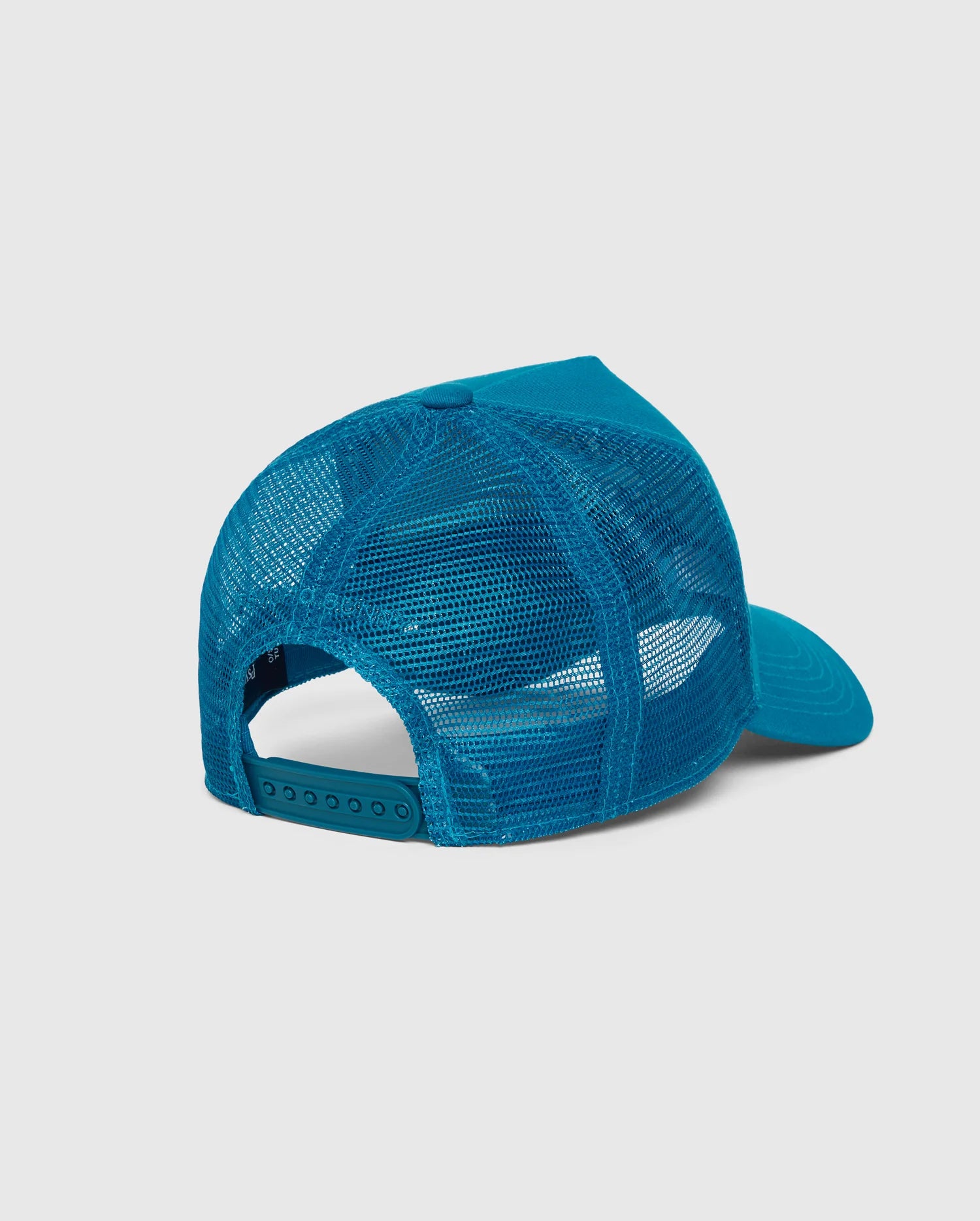 The Psycho Bunny MENS MALTON TRUCKER CAP - B6A797D200, a blue mesh-back trucker cap with an adjustable snap closure, is displayed against a plain white background. Made from 100% cotton, the cap is shown from the back to highlight its mesh ventilation and snap adjustment.