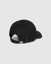 A Psycho Bunny MENS CLASSIC BASEBALL CAP - B6A816A1HT is shown from the back. The black cotton twill cap features an adjustable strap with a metal buckle and a small round vent hole on the side. The background is a plain grey.