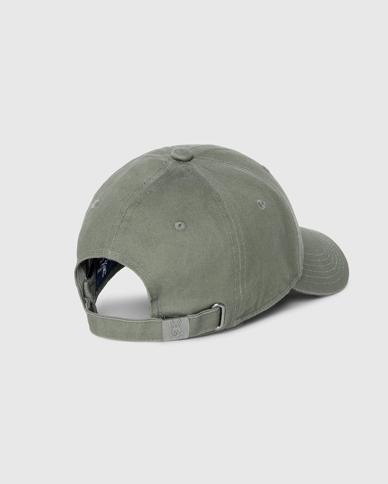The Psycho Bunny MENS CLASSIC BASEBALL CAP - B6A816B200, crafted from 100% cotton in a solid pattern, is shown from the back with an adjustable strap and metal buckle against a light gray background.