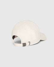 The MENS CLASSIC BASEBALL CAP - B6A816B200 by Psycho Bunny, crafted from 100% cotton in a classic beige shade, is displayed from the back against a plain light background. It boasts a curved brim, an adjustable strap with a metal clasp, and a side ventilation hole for enhanced comfort.