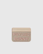 A premium beige leather cardholder features "PSYCHO BUNNY" embroidered in pink on the front. The minimalist MENS LEATHER CARD CASE - B6A869D200 by Psycho Bunny offers style and simplicity, set against a plain white background.