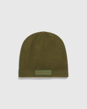 The MENS SPORT BEANIE - B6A874D200 by Psycho Bunny is a premium olive green knitted hat made from merino wool, featuring a small rectangular "Psycho Bunny" patch on the front. It is showcased against a light gray background, emphasizing its high-performance quality.