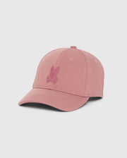 The Psycho Bunny MENS JAMES PREMIUM BASEBALL CAP - B6A953D200 is a pink cap featuring an embroidered Bunny and crossbones emblem on the front. Crafted from polyester spandex, this cap is elegantly showcased against a plain white background, highlighting its distinctive design and structure.