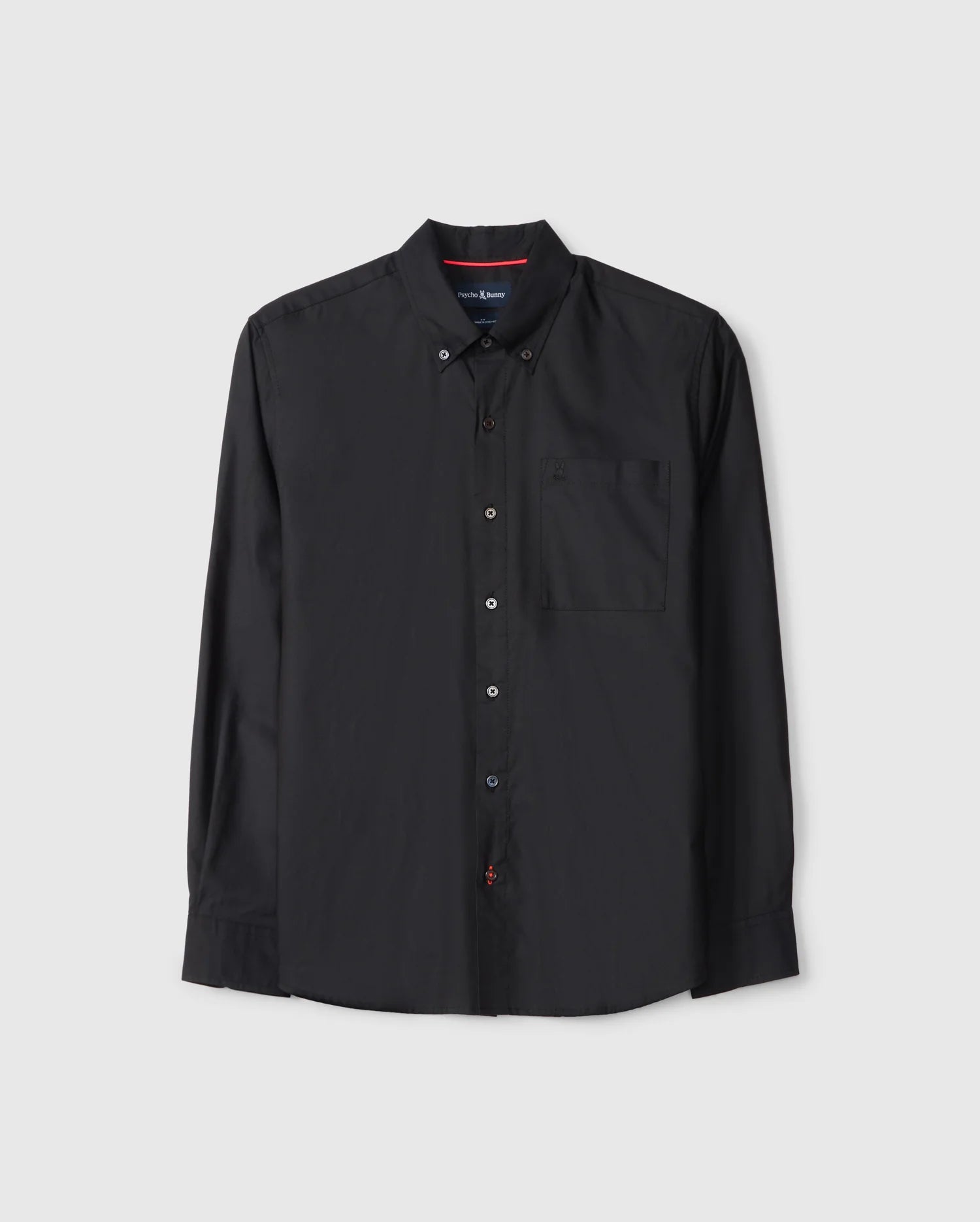 The Psycho Bunny MENS JARED COTTON MODAL SHIRT (B6C774D200) is a black long-sleeve button-up with a collar and chest pocket, crafted from soft modal fabric. It features a simple design with red stitching detail on the second buttonhole.
