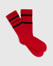 The MENS SPORT SOCK BOX SET - B6F268E200 by Psycho Bunny includes a pair of red sport socks for men, crafted from luxurious Peruvian Pima Cotton. These socks feature black bands near the top and have the "Psycho Bunny" logo in black. They are designed with moisture-wicking properties and are displayed flat against a plain background.