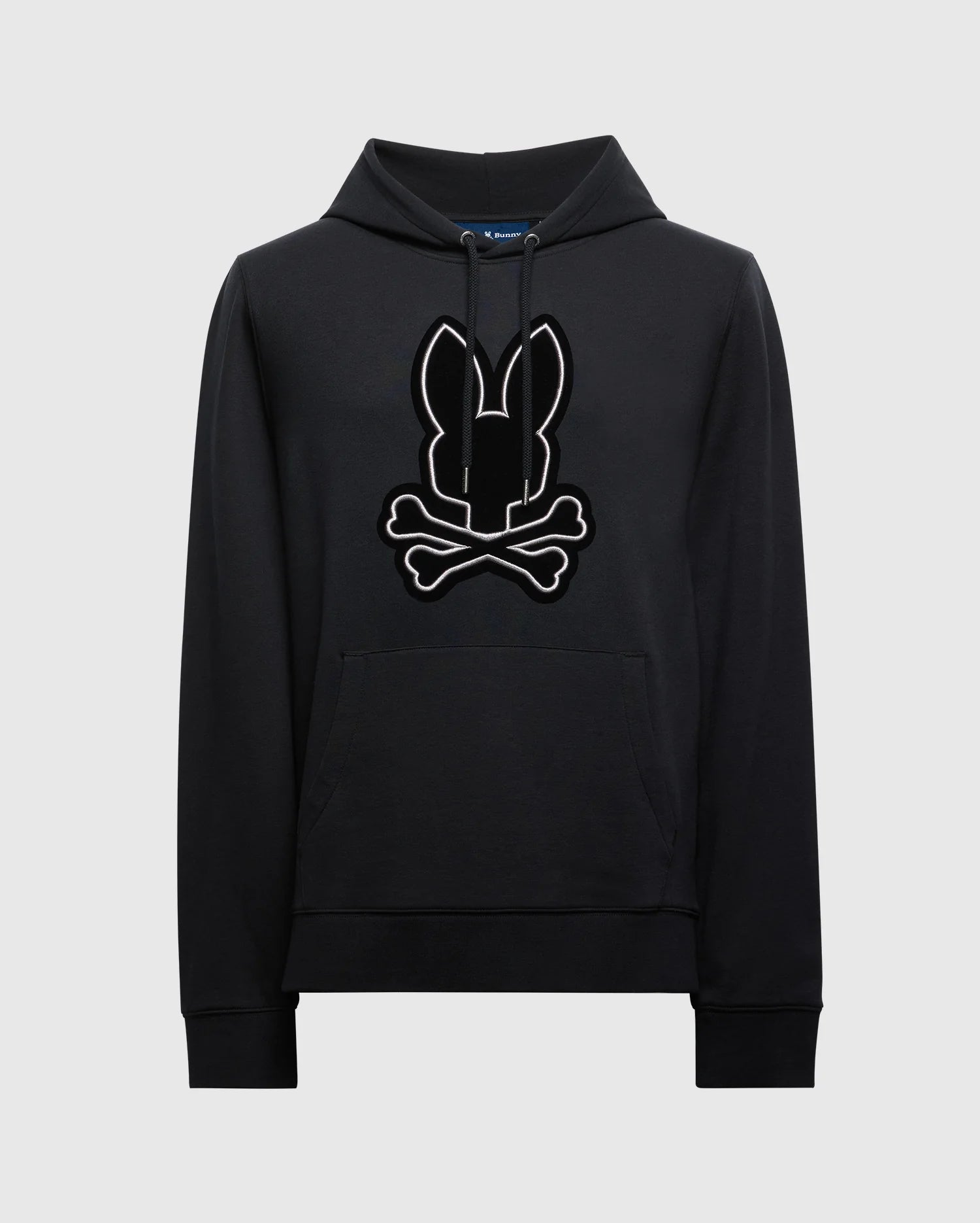 The MENS ALEXANDER HOODIE - B6H154E200 from Psycho Bunny is crafted for comfort, featuring a kangaroo pocket and adorned with a stylized bunny head and crossbones graphic on the front.