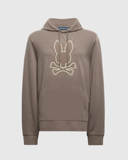 The Psycho Bunny MENS ALEXANDER HOODIE - B6H154E200 is a comfortable men's cotton blend pullover hoodie available in brown. It includes a kangaroo pocket and a hood, featuring a stylized design of bunny ears above crossed bones on the chest.