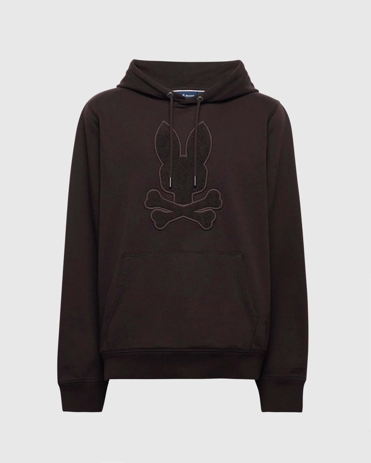 The Psycho Bunny MENS ELDORADO BRUSH BACK HOODIE - B6H234E200 in black features a rabbit head with crossed bones on the front, has a cozy kangaroo pocket, and drawstrings at the neck, set against a plain white background.